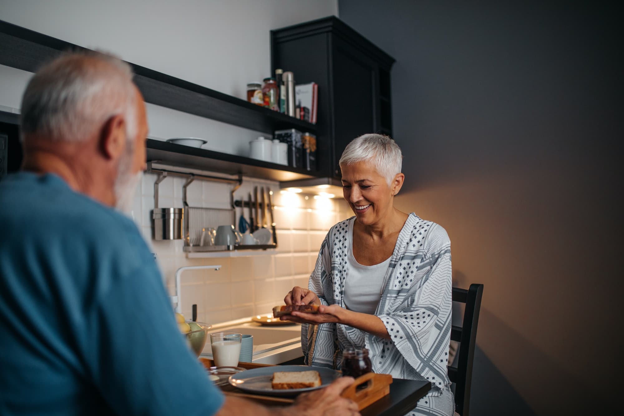 Older people eating in kitchen